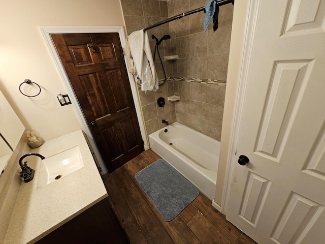 bathroom with shower / tub combination, wood finished floors, and vanity