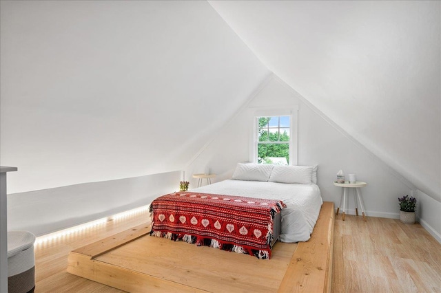 bedroom featuring vaulted ceiling and wood finished floors