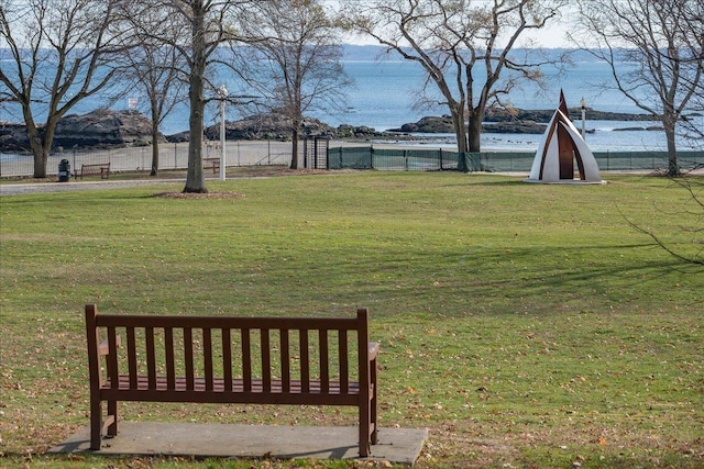 view of yard with fence and a water and mountain view