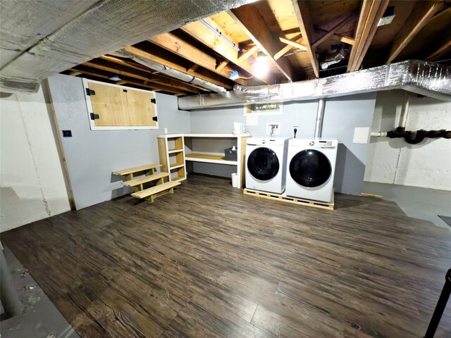 clothes washing area with dark hardwood / wood-style flooring and washer and clothes dryer