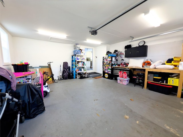 garage with a garage door opener and a workshop area