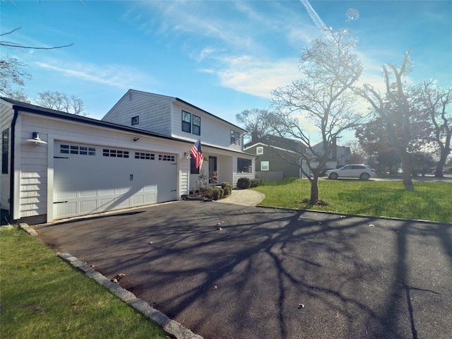 view of front of home with a garage and a front yard