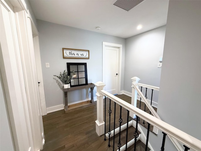 corridor with dark hardwood / wood-style flooring