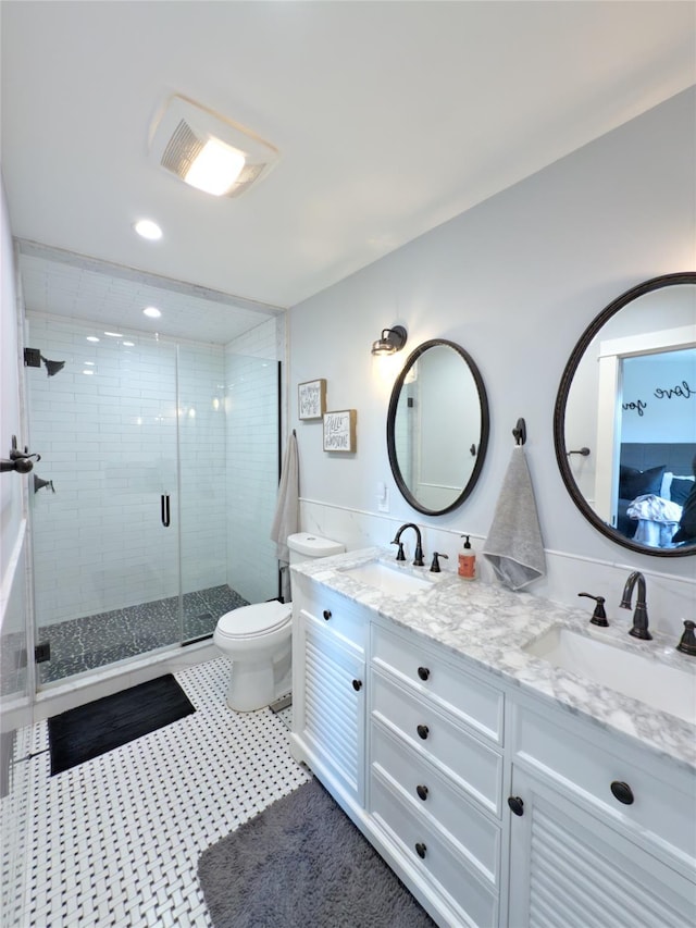 bathroom with vanity, an enclosed shower, and toilet