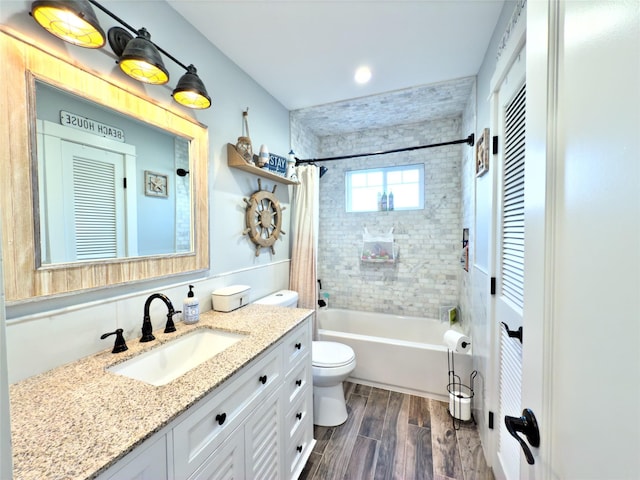 full bathroom featuring shower / bath combo, hardwood / wood-style floors, vanity, and toilet