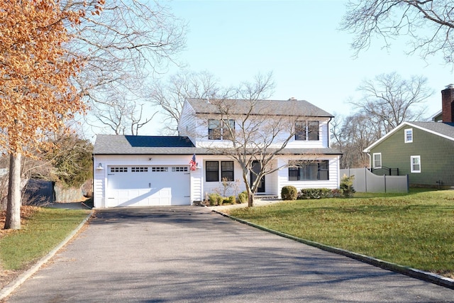 view of front property with a garage and a front lawn