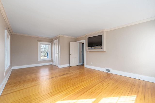 spare room featuring hardwood / wood-style flooring and ornamental molding