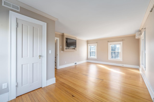 unfurnished living room with ornamental molding and light hardwood / wood-style floors