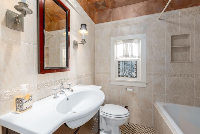 full bathroom featuring vanity, toilet, tiled shower / bath combo, and tile walls