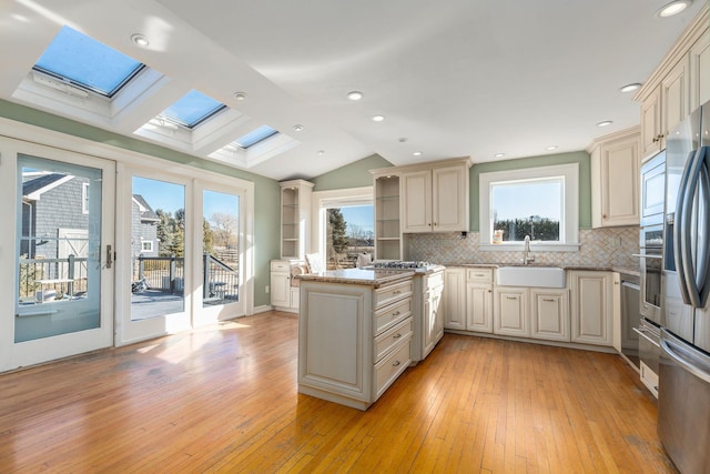 9875 Main Bayview Rd, Southold, NY 11971 - kitchen with a skylight, open shelves, cream cabinetry, backsplash, and recessed lighting