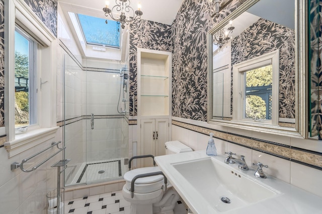 9875 Main Bayview Rd, Southold, NY 11971 - full bath with wallpapered walls, wainscoting, a shower stall, a skylight, and a chandelier