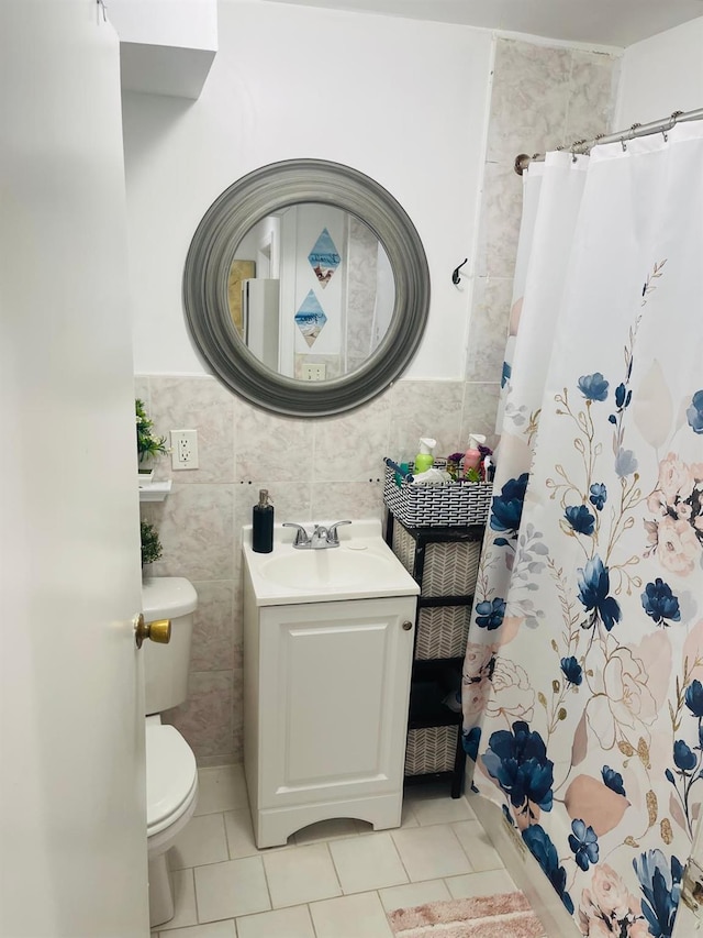 bathroom featuring tile walls, tile patterned flooring, vanity, a shower with curtain, and toilet