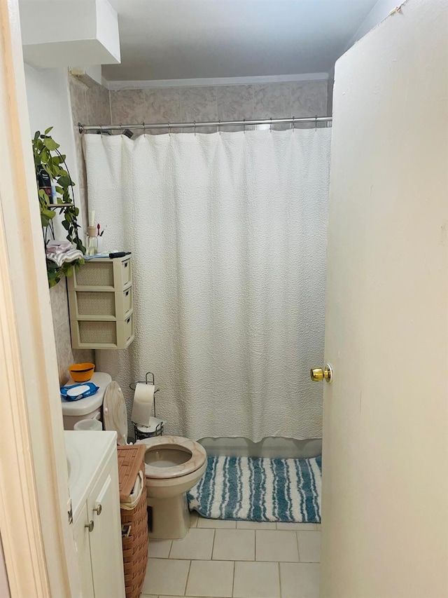 bathroom with vanity, toilet, curtained shower, and tile patterned flooring