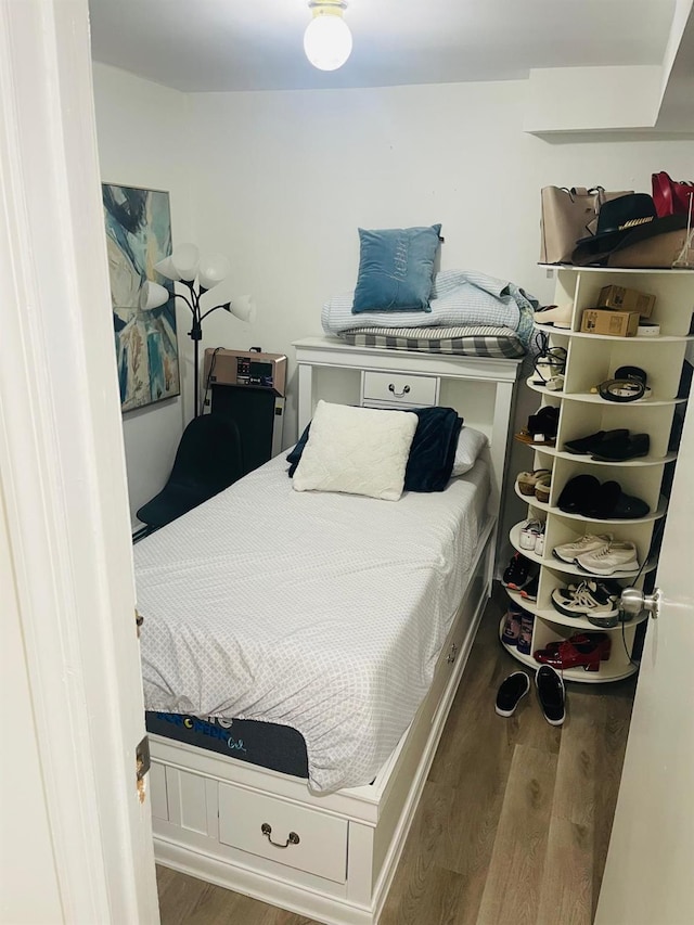 bedroom with dark wood-type flooring