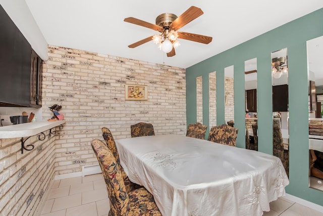 tiled dining space featuring brick wall and ceiling fan