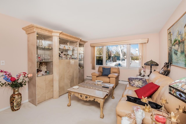 sitting room featuring a baseboard radiator and carpet floors