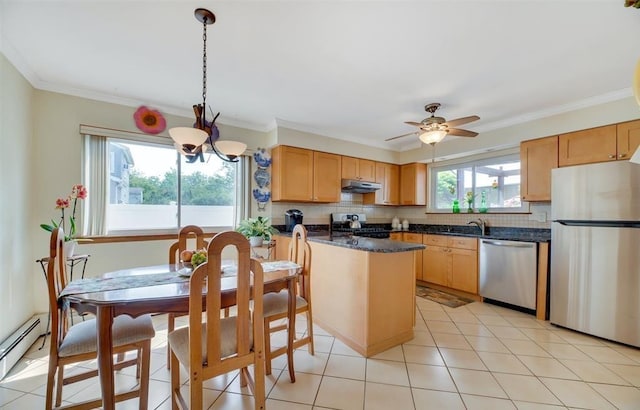 kitchen with hanging light fixtures, baseboard heating, appliances with stainless steel finishes, ornamental molding, and decorative backsplash