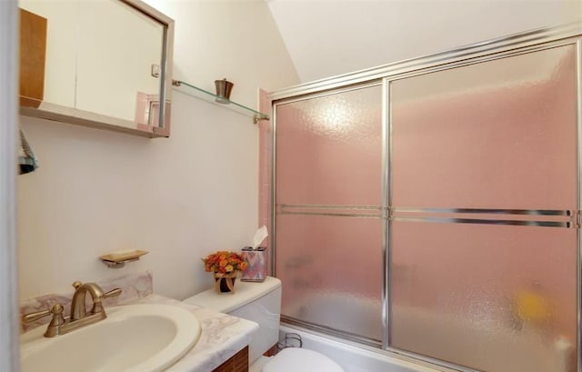 full bathroom with enclosed tub / shower combo, vanity, and toilet