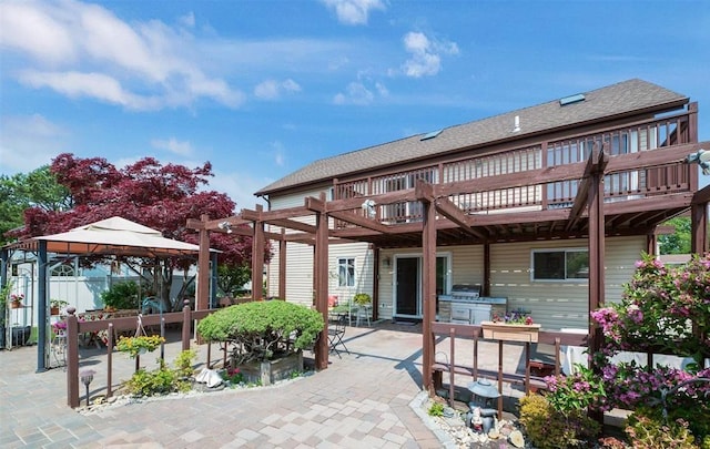 back of property featuring a pergola, a gazebo, a patio, and a balcony