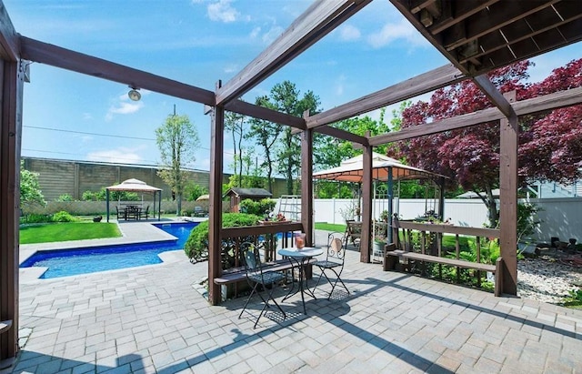 view of patio / terrace with a gazebo and a fenced in pool