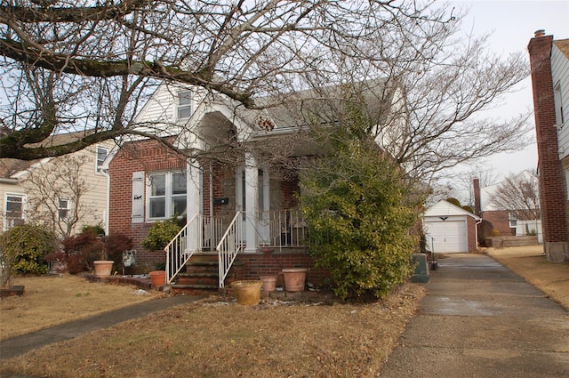 view of front facade featuring a garage and an outbuilding