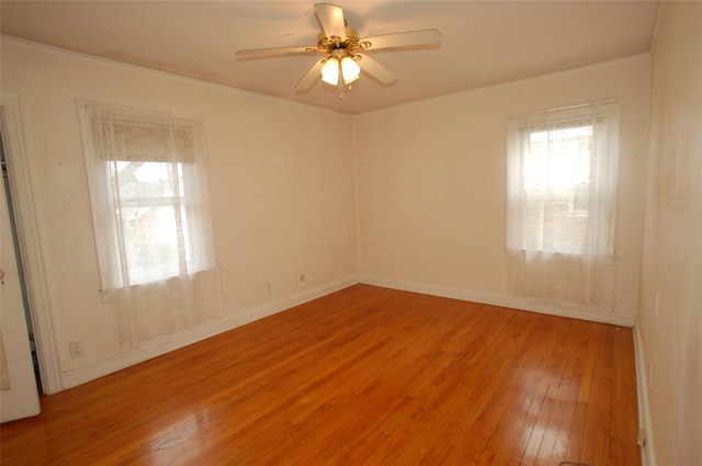 spare room with hardwood / wood-style flooring, ceiling fan, and crown molding