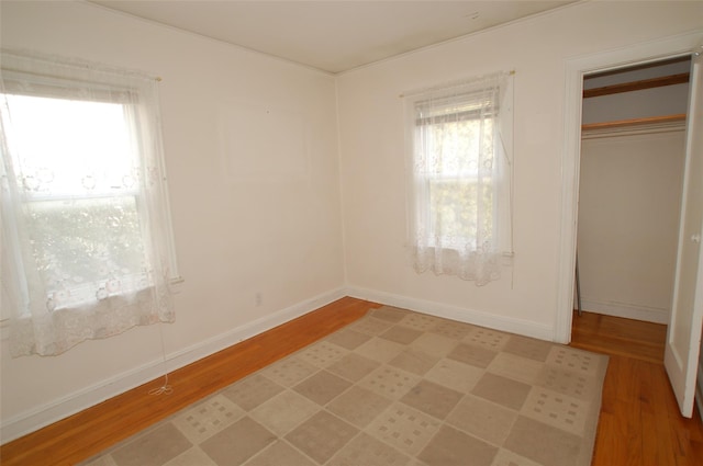 unfurnished bedroom with a closet and light wood-type flooring