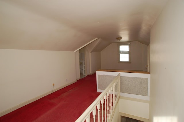 additional living space featuring carpet and lofted ceiling