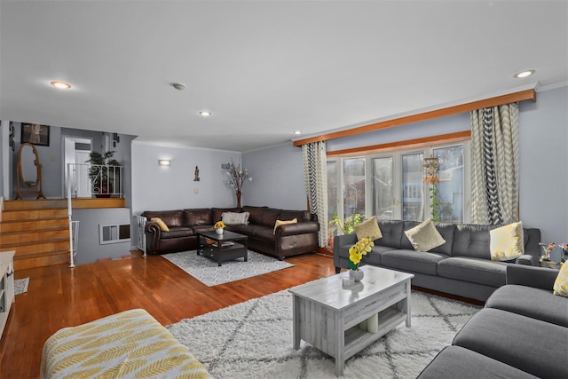 living room with ornamental molding and light hardwood / wood-style floors