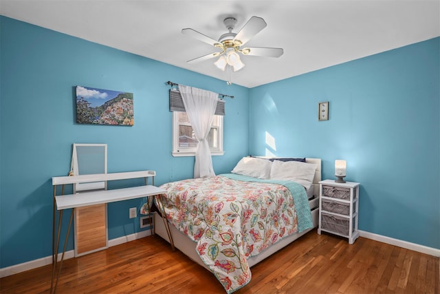 bedroom featuring ceiling fan and dark hardwood / wood-style flooring