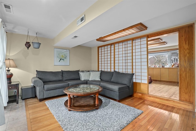 living area featuring visible vents and light wood-type flooring