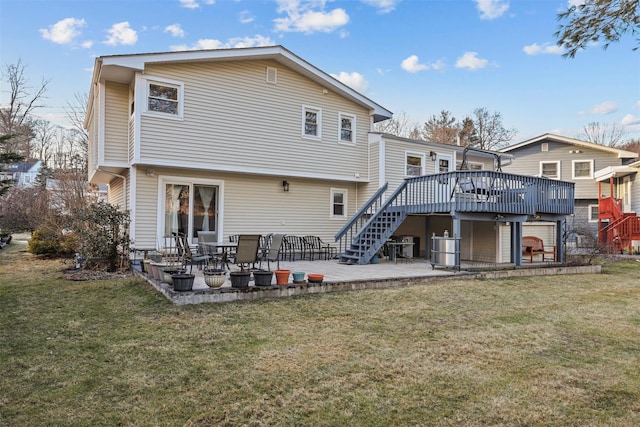 back of property with a wooden deck, a yard, and a patio area