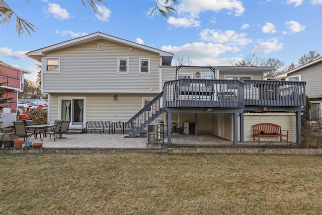 back of house featuring a wooden deck, a yard, and a patio area