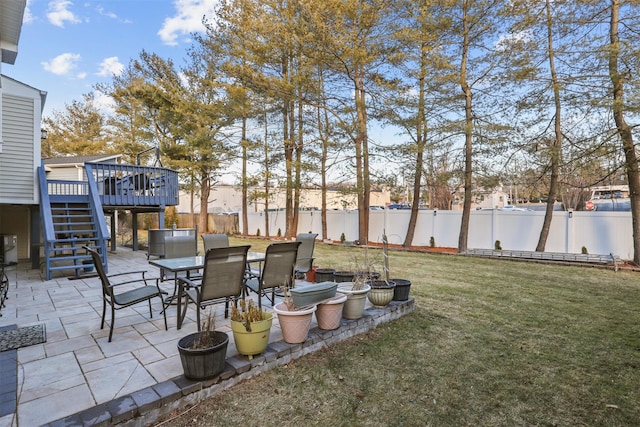 view of yard with a wooden deck and a patio