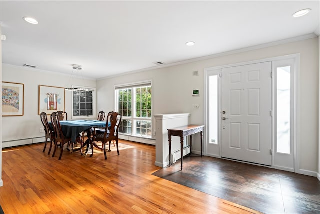 entrance foyer featuring dark hardwood / wood-style flooring, ornamental molding, and baseboard heating