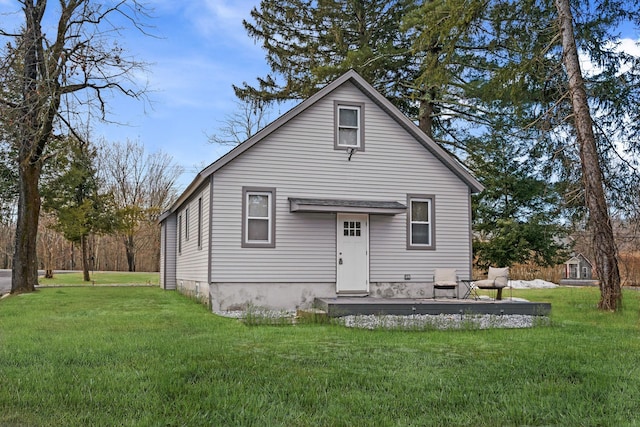 rear view of property featuring a yard