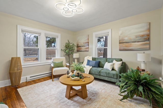 living room featuring a baseboard heating unit and hardwood / wood-style floors