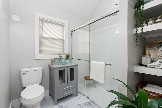 bathroom with lofted ceiling, toilet, a shower with door, and vanity