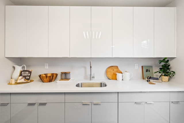 interior space featuring sink and white cabinets