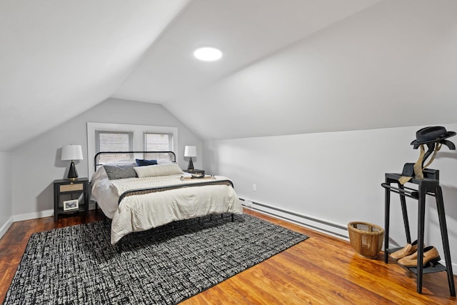 bedroom with hardwood / wood-style flooring, vaulted ceiling, and baseboard heating