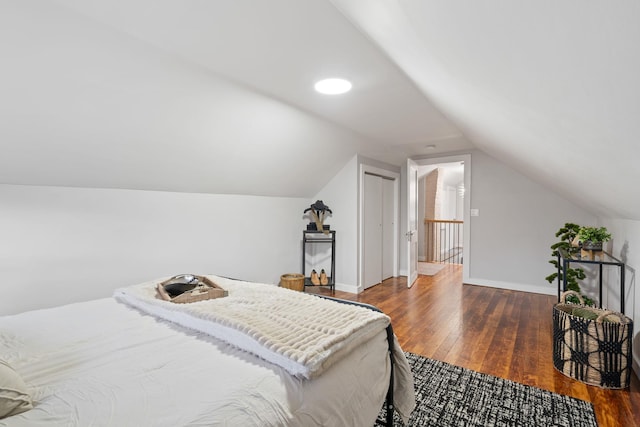 bedroom with lofted ceiling and dark hardwood / wood-style floors