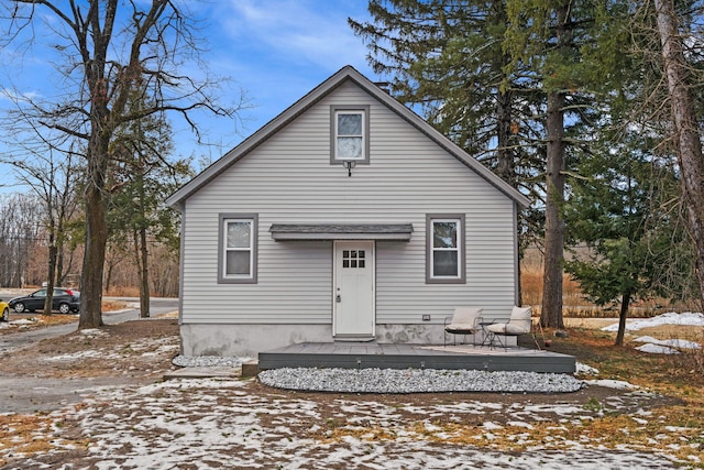 snow covered house with a wooden deck