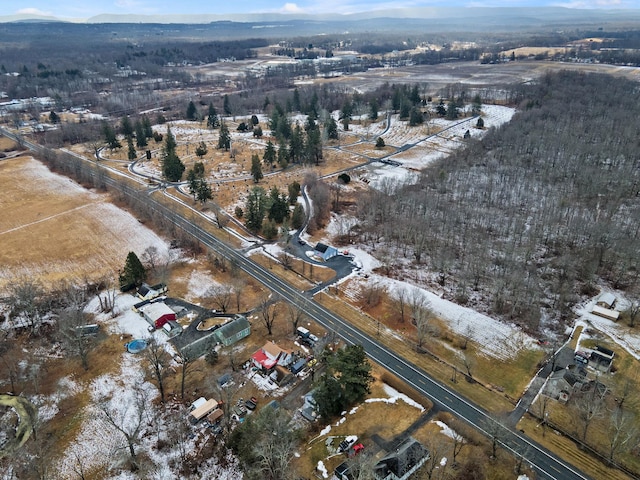 snowy aerial view featuring a mountain view