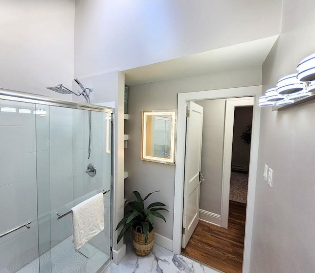 bathroom with a shower with door