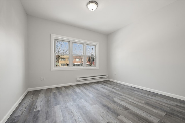 empty room featuring a baseboard radiator and hardwood / wood-style floors