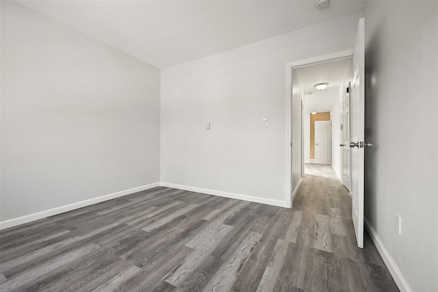 unfurnished room featuring dark hardwood / wood-style floors