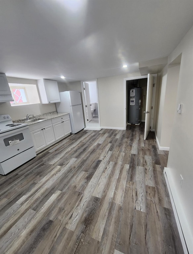 kitchen featuring sink, wood-type flooring, white appliances, water heater, and white cabinets