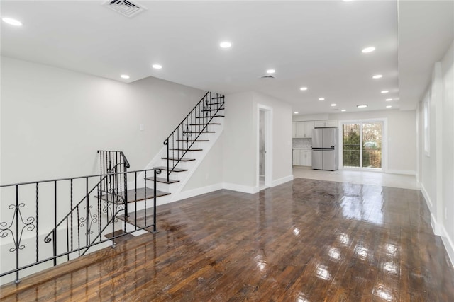 unfurnished living room with hardwood / wood-style flooring