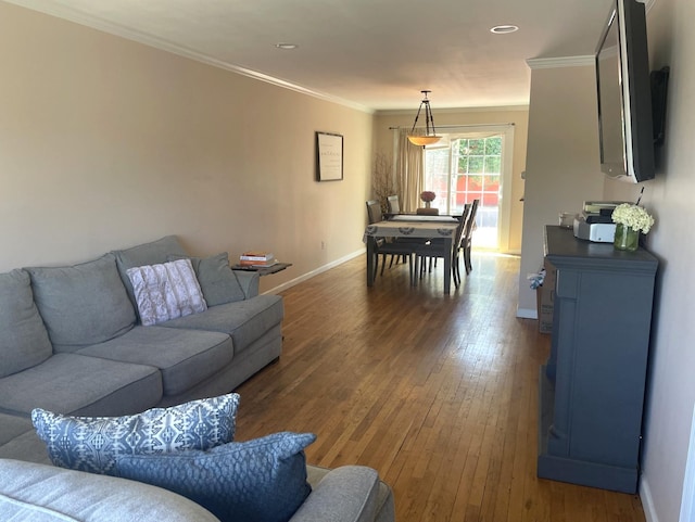 living room featuring ornamental molding and dark wood-type flooring