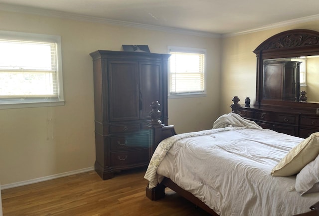 bedroom featuring wood-type flooring and ornamental molding